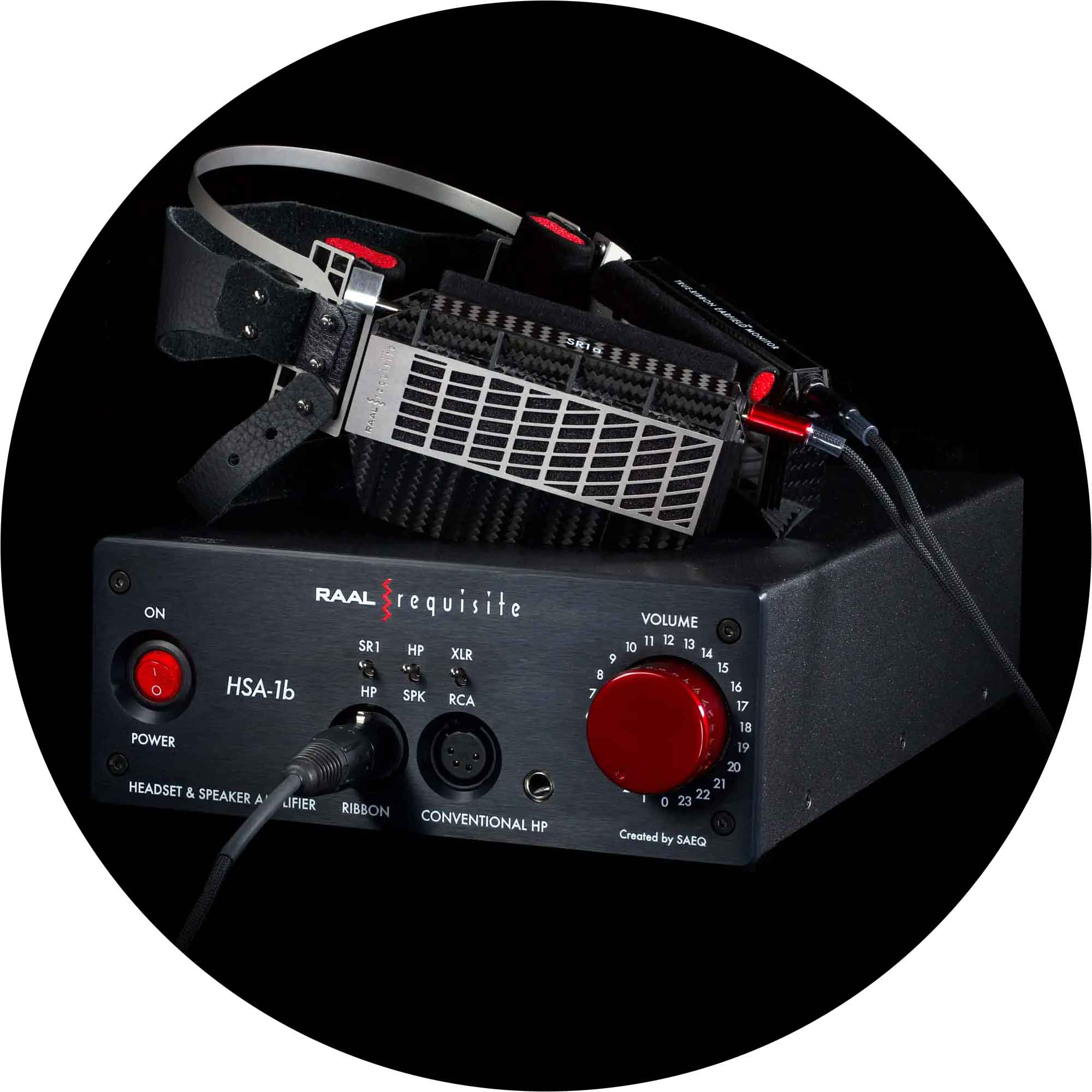 RAAL-requisite SR1a Ribbon Headphone resting on a black amplifier with volume knob and connector ports visible