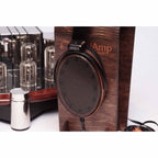 Sennheiser Orpheus HE90 / HEV90 electrostatic headphones resting on wooden stand with vacuum tube amplifier in background
