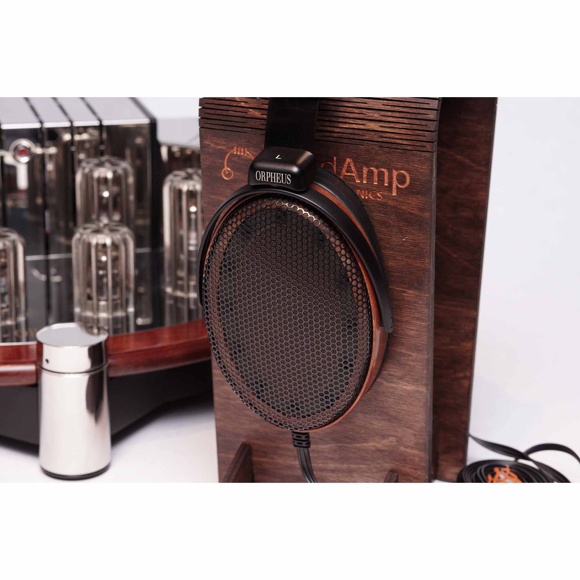 Sennheiser Orpheus HE90 / HEV90 electrostatic headphones resting on wooden stand with vacuum tube amplifier in background