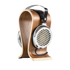 HIFIMAN Shangri-La Jr. Electrostatic Headphones with metal ear cups resting on curved wooden headphone stand on white background