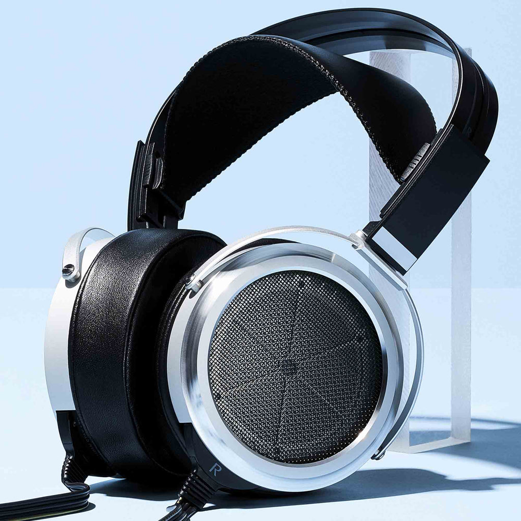 STAX SR-009 Open-Back Electrostatic Headphones with silver ear cups and black leather headband on clear stand