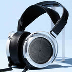 STAX SR-009 Open-Back Electrostatic Headphones with silver ear cups and black leather headband on clear stand