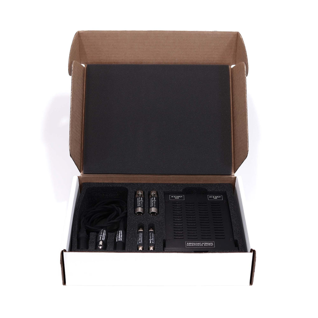 Open box showing RAAL-requisite TI-1 Amp Interface for True-Ribbon™ Headphones with cables and components on white background