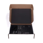 Open box showing RAAL-requisite TI-1 Amp Interface for True-Ribbon™ Headphones with cables and components on white background