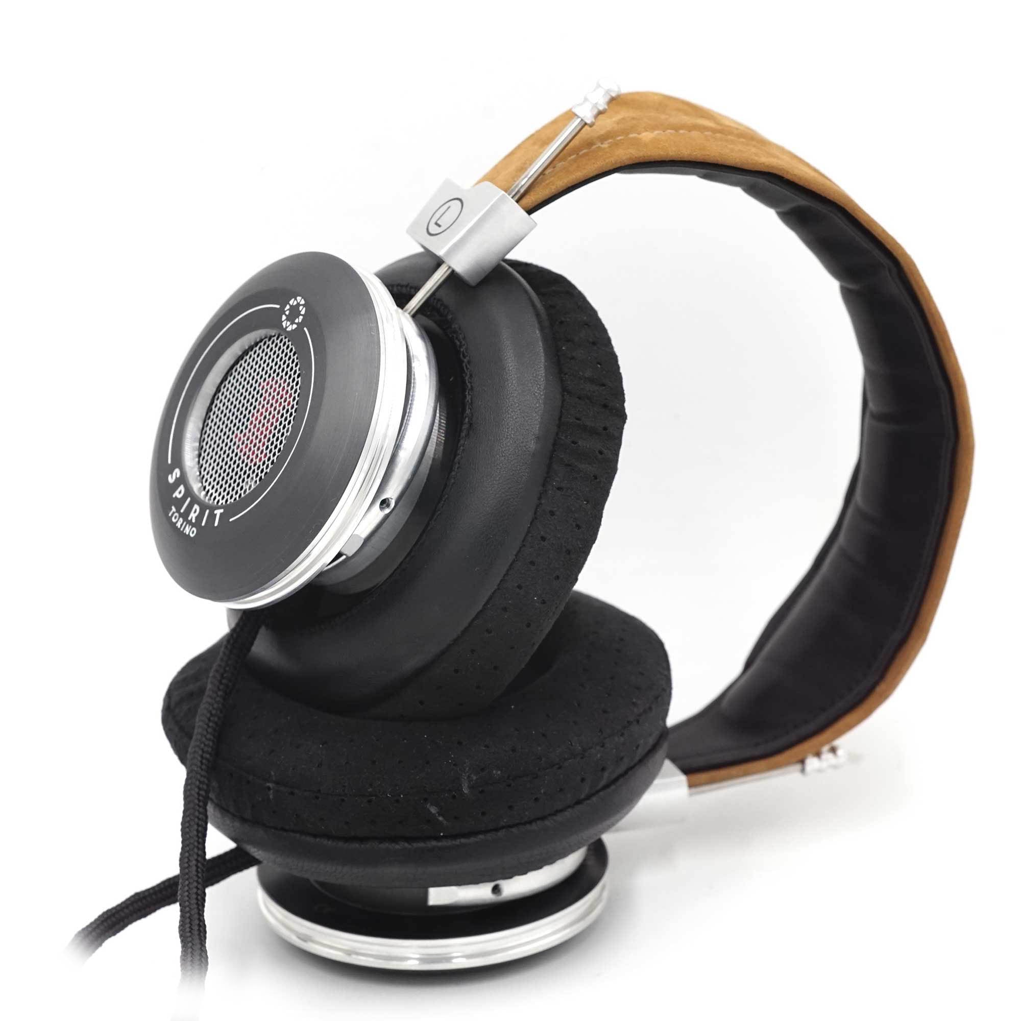 Close-up of Spirit Torino Twin Pulse dynamic open back headphones with black ear pads and brown padded headband on white background