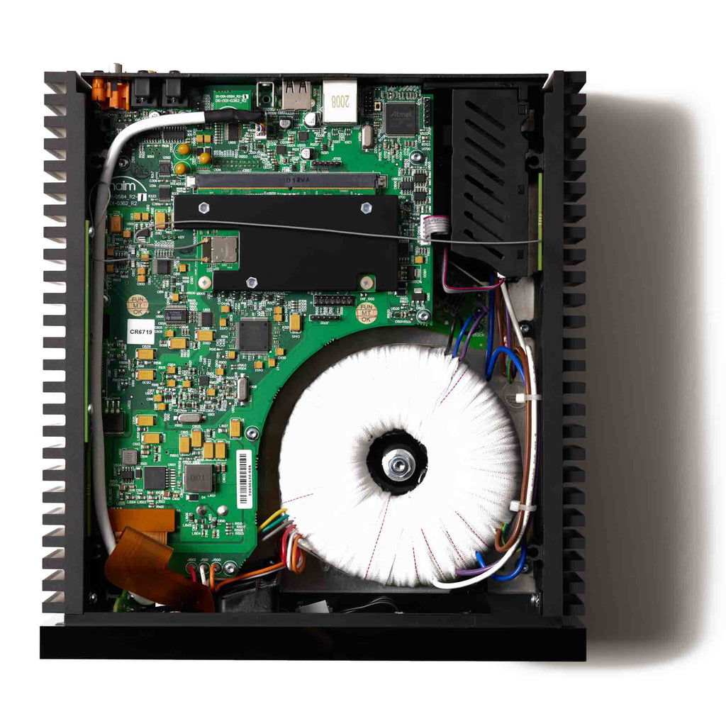 Internal view of the NAIM Uniti Atom Headphone Edition showing circuit board and large toroidal transformer from above